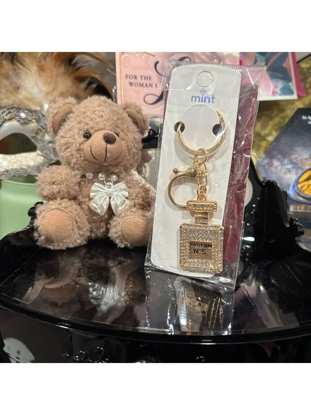 725. Gold-tone perfume bottle charm labeled 